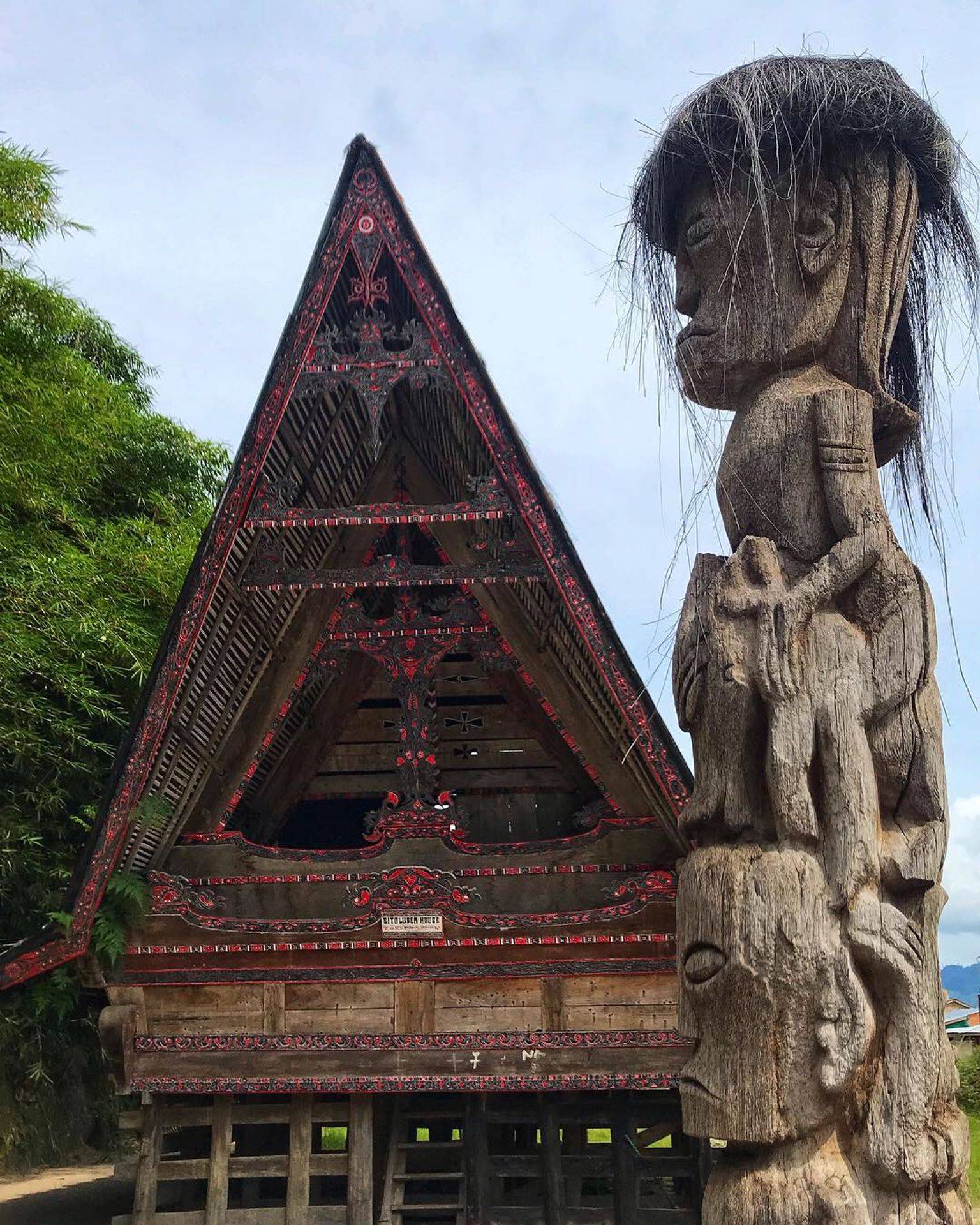 Traditional Batak house with carved peaked roof on Samosir island, Lake Toba